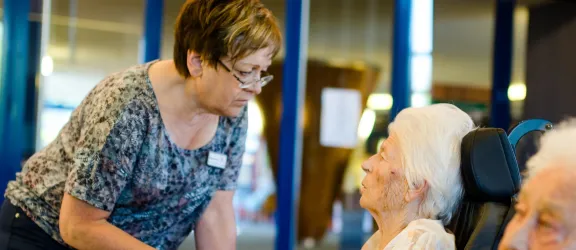 Frauen im Rollstuhl und Mitarbeiterin der Rummelsberger Diakonie