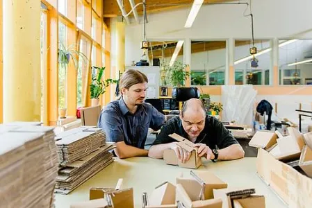 Zwei Menschen arbeiten an einem Tisch
